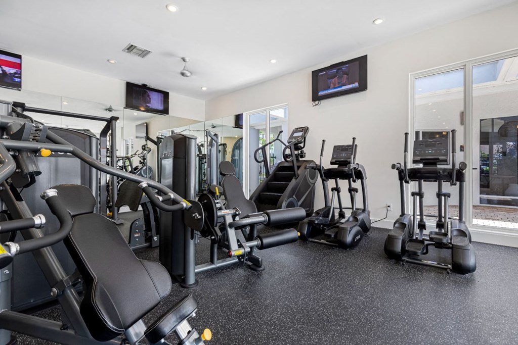 the gym is equipped with cardio equipment and televisions