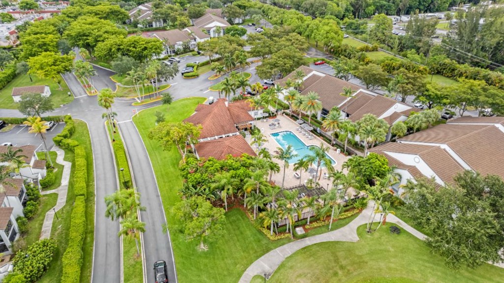 an aerial view of a neighborhood with houses and a swimming pool