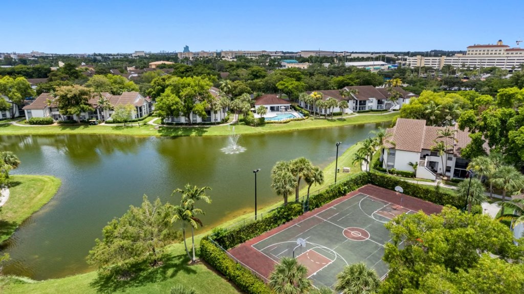 an aerial view of a basketball court near a body of water