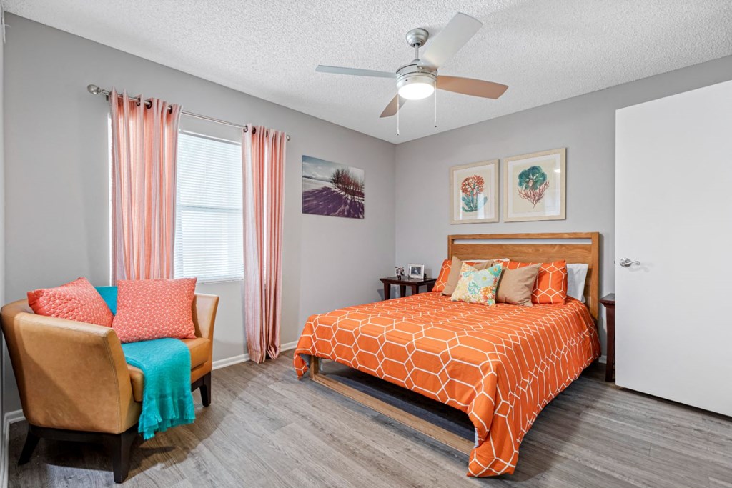 a bedroom with a bed and a ceiling fan