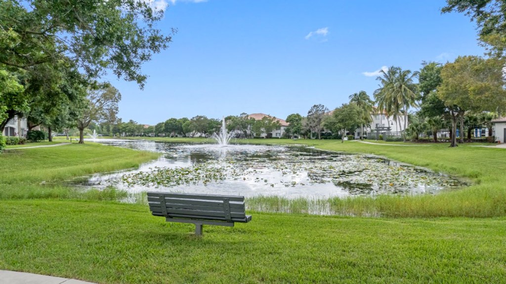 a park bench sitting in front of a pond