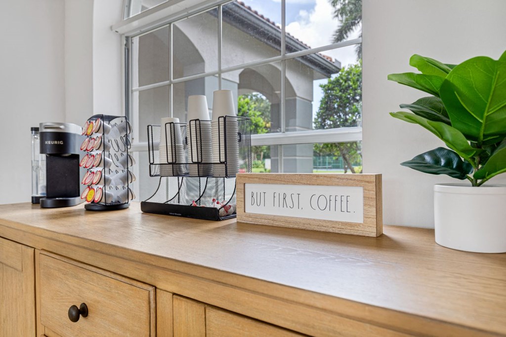 a kitchen counter with a sign that says but first coffee