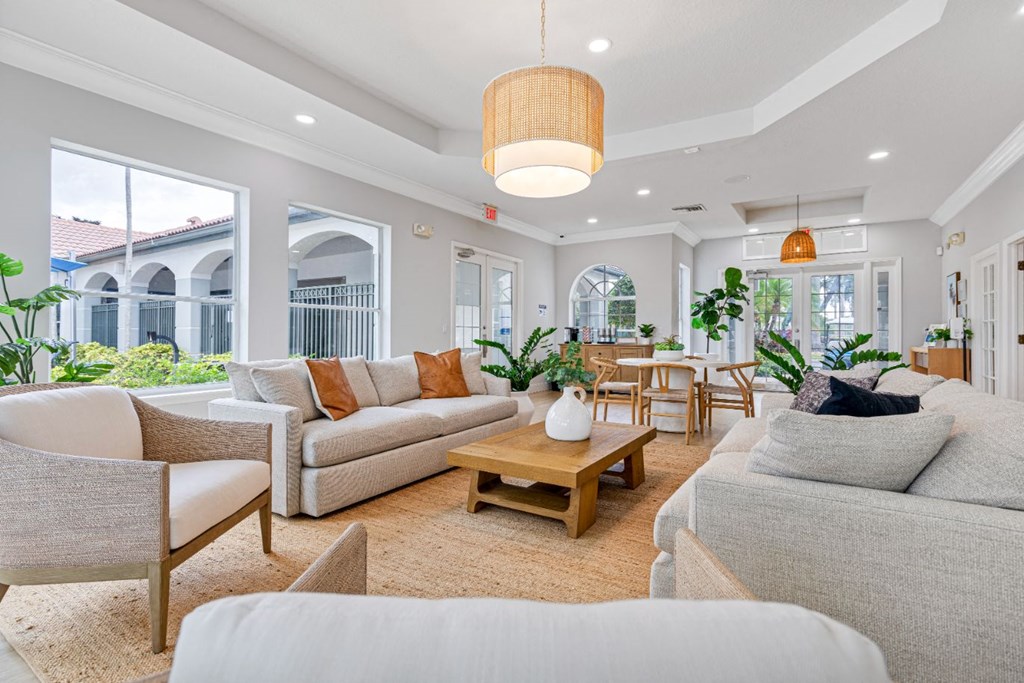 a living room with couches and chairs and a table