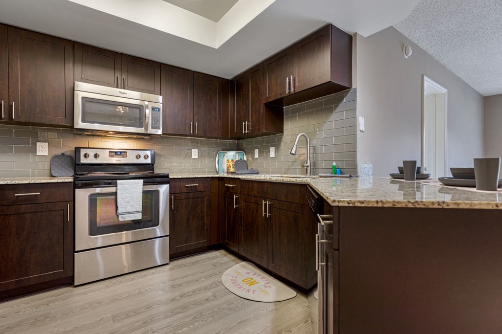 a kitchen with stainless steel appliances and wooden cabinets