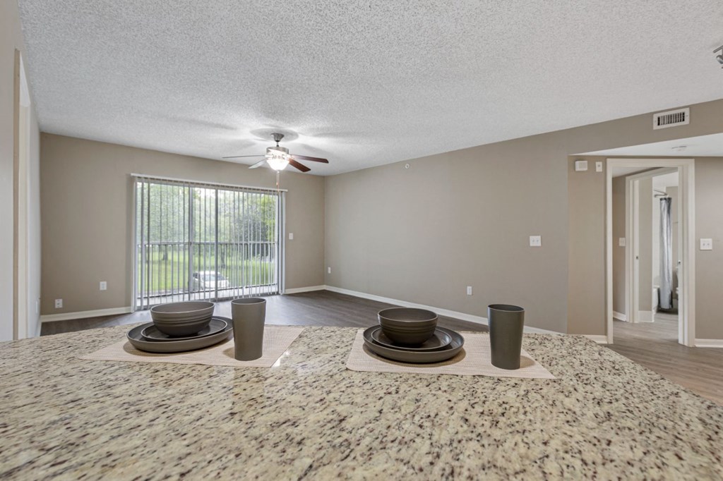 a dining room with a table and a ceiling fan