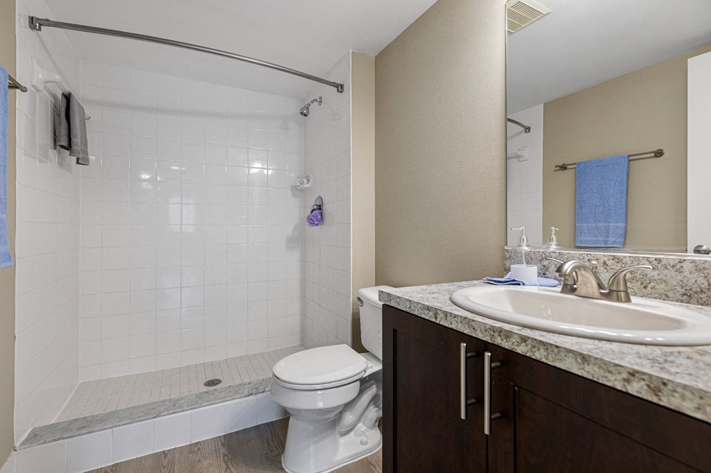 a bathroom with a sink toilet and shower