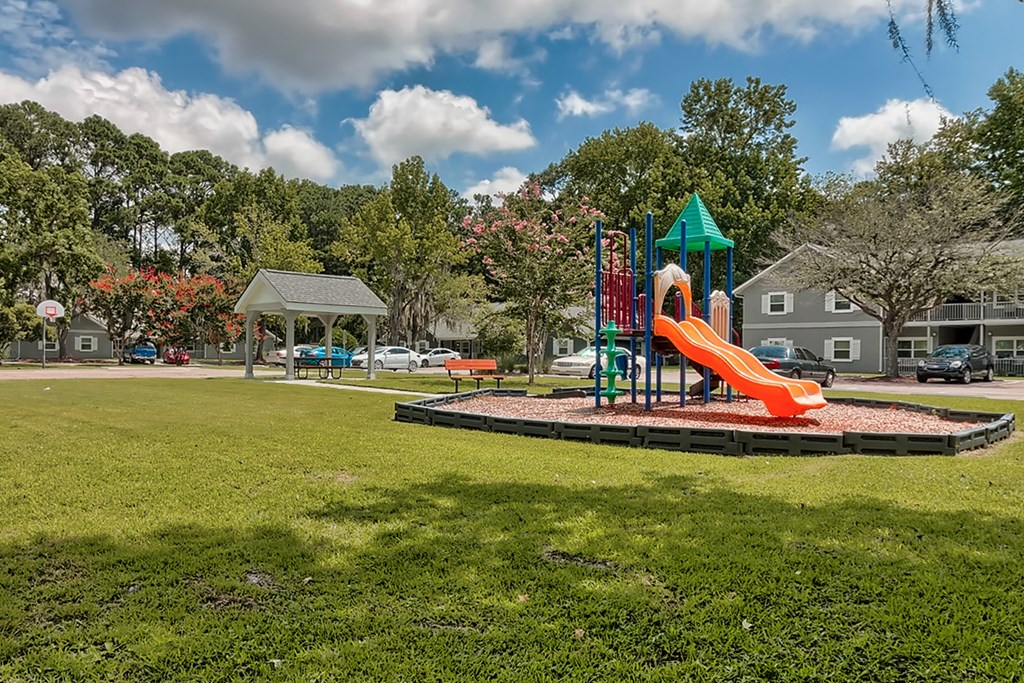 a playground with a slide in a park