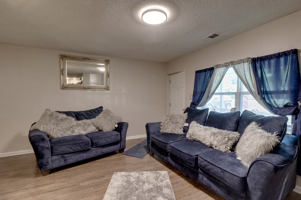 a living room with two couches and a window