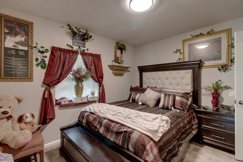 a bedroom with a bed and a teddy bear