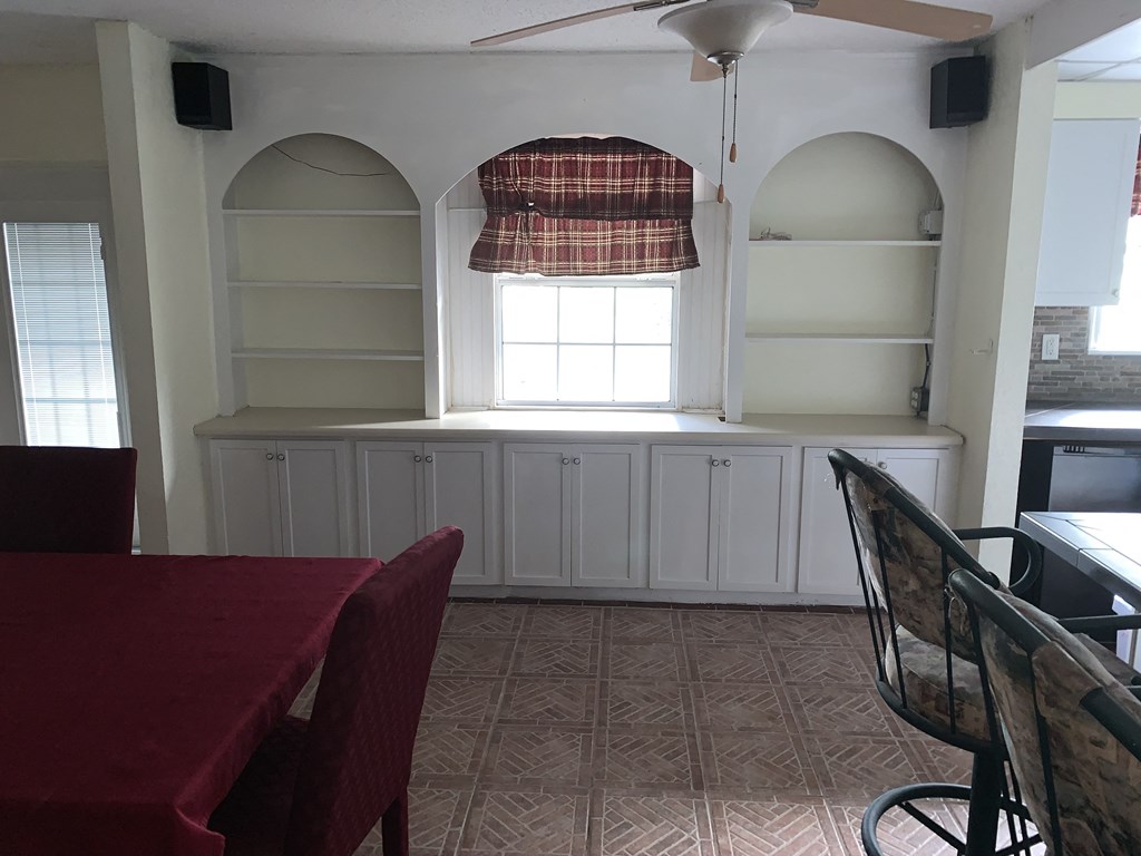 a dining room with white cabinets and a table and chairs