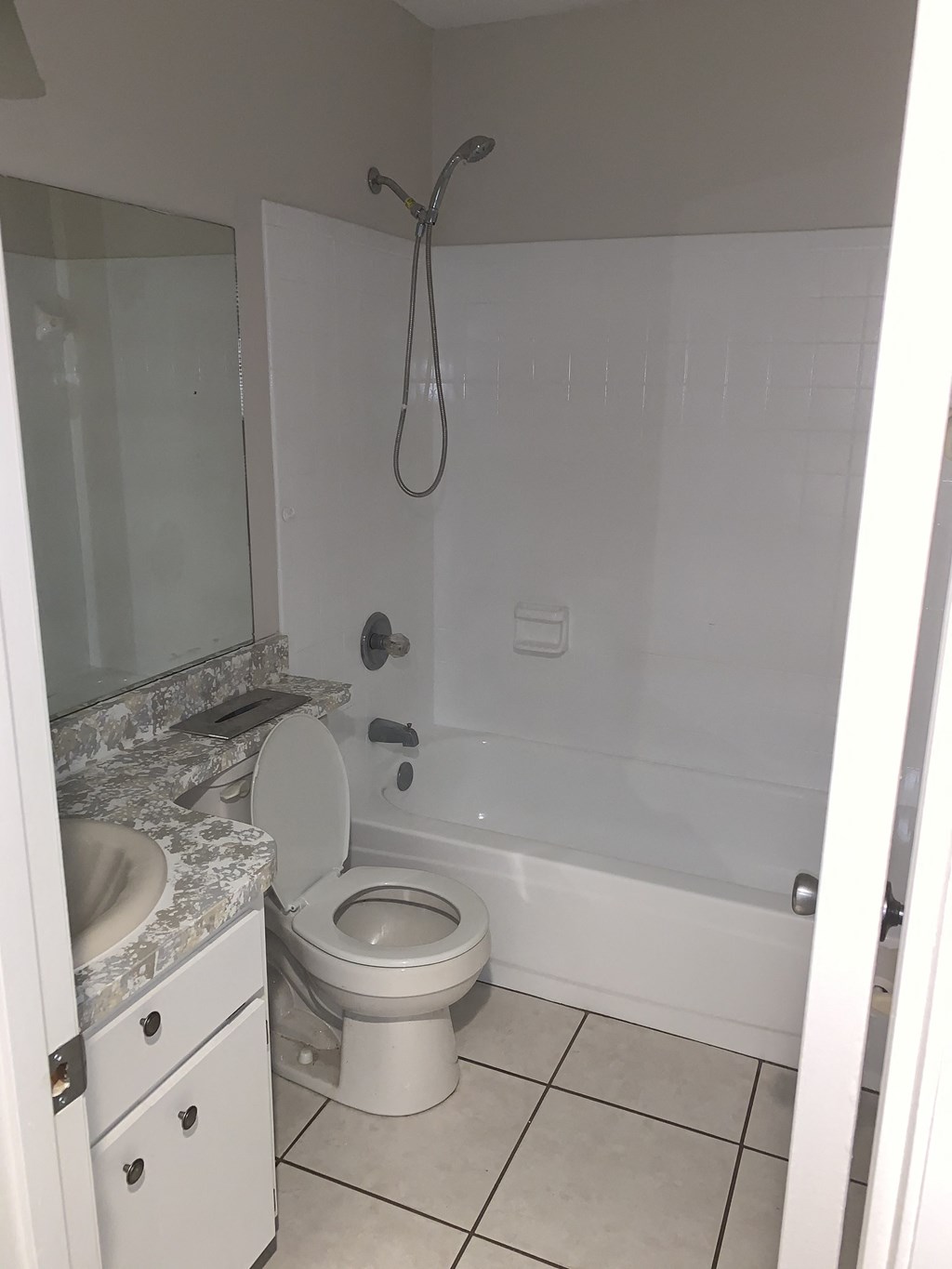 a bathroom with a toilet and a tub and a sink