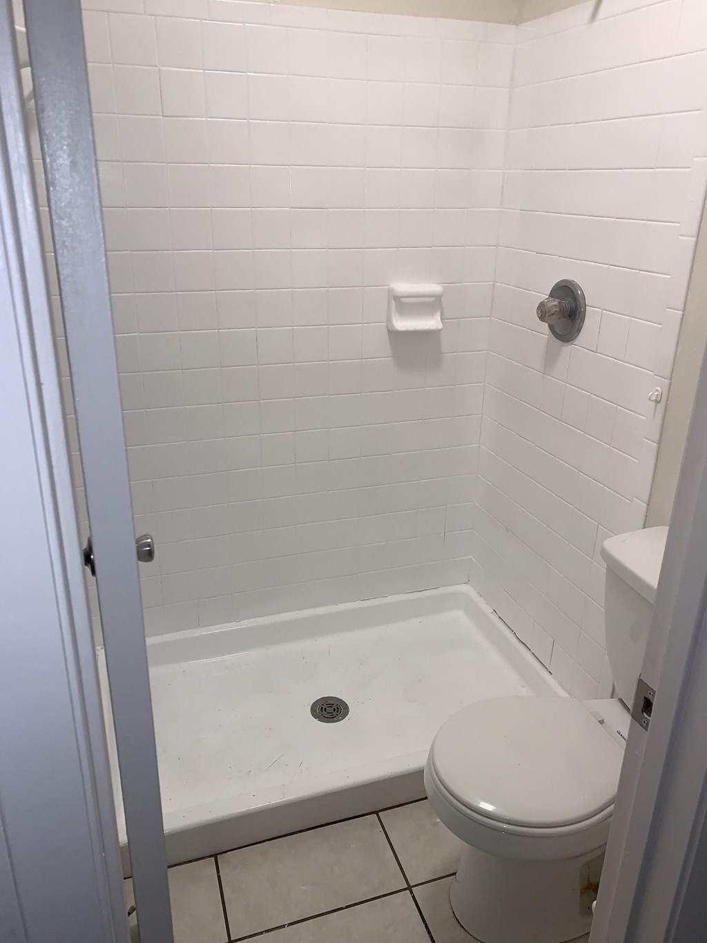 a small bathroom with a toilet and a shower