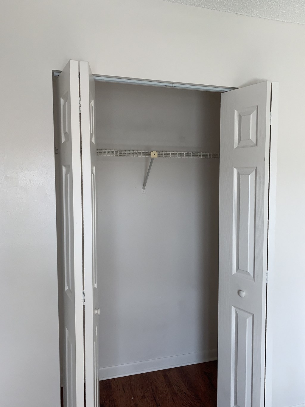 an empty closet in a room with a white door