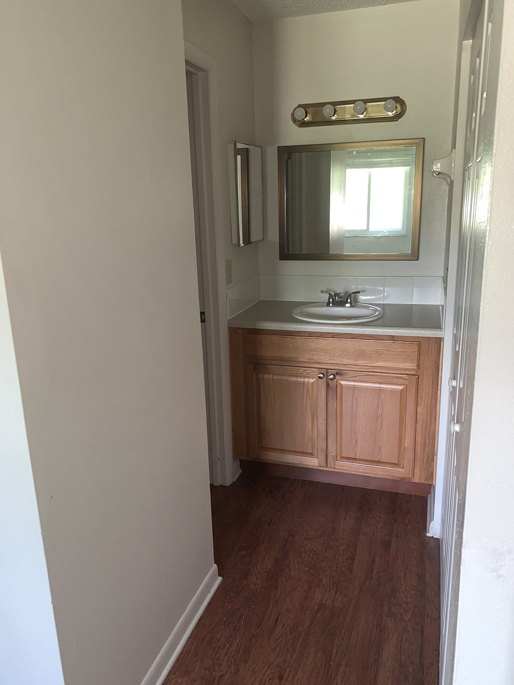 a small bathroom with a sink and a mirror