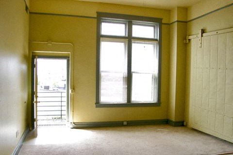 an empty room with a window and a door