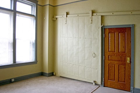 an empty room with a door and a window