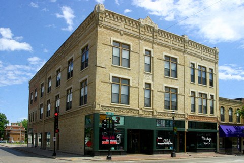 a large brick building on the corner of a city street