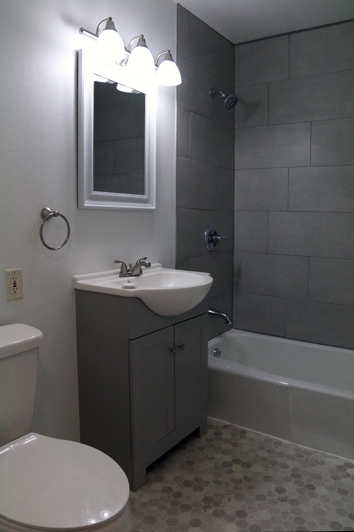 a small bathroom with a sink toilet and shower