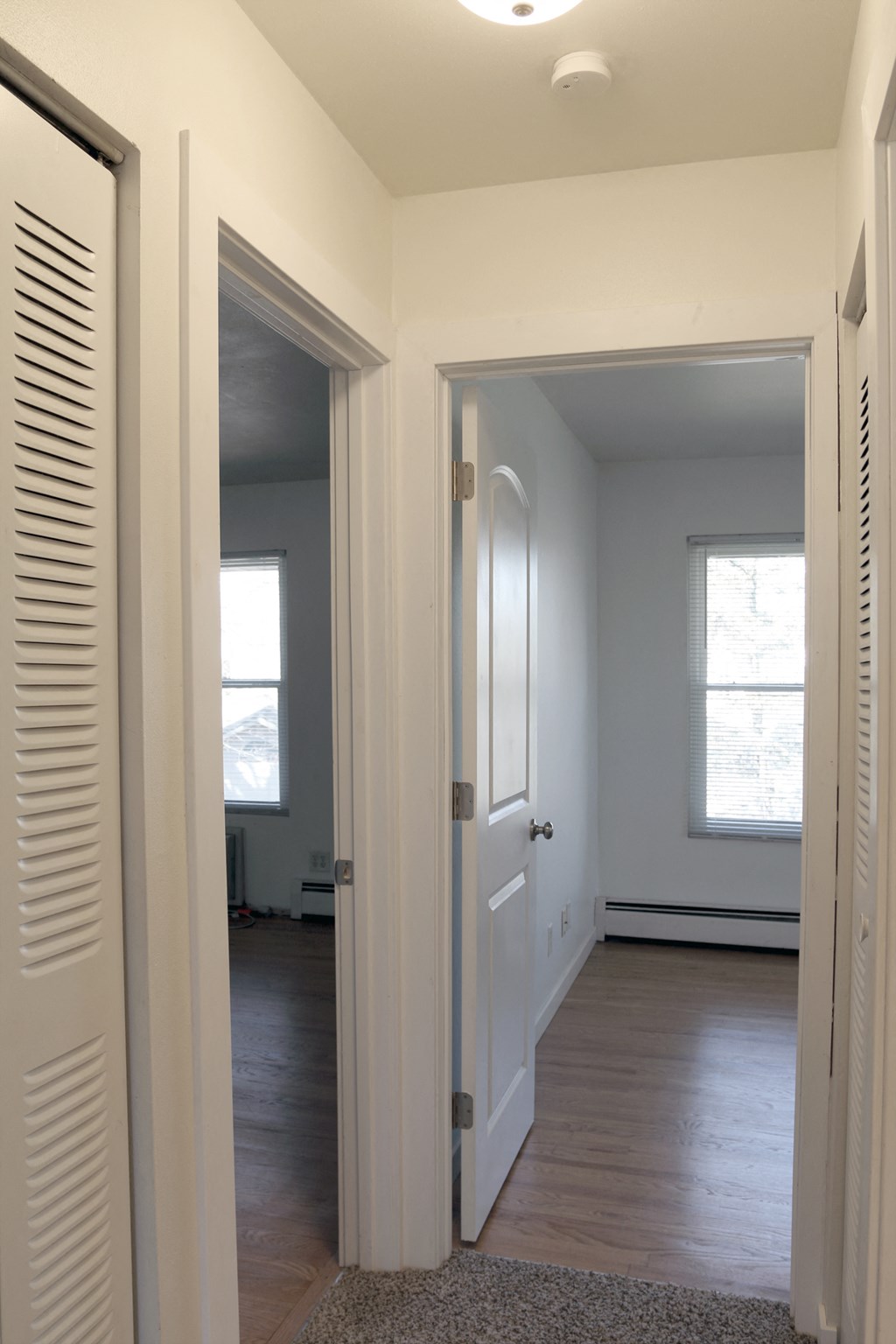 a view of the hallway from the living room into the dining room