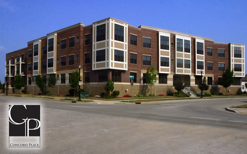 a large brick building with a street in front of it
