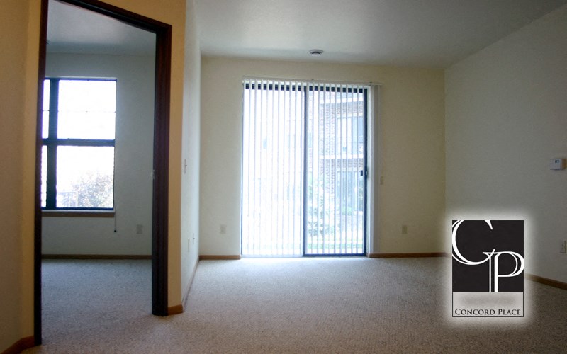 an empty living room with a sliding glass door