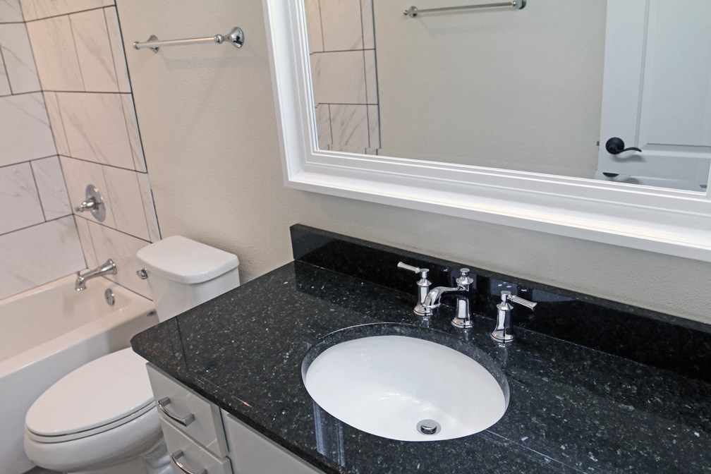 a bathroom with a sink and a mirror and a toilet