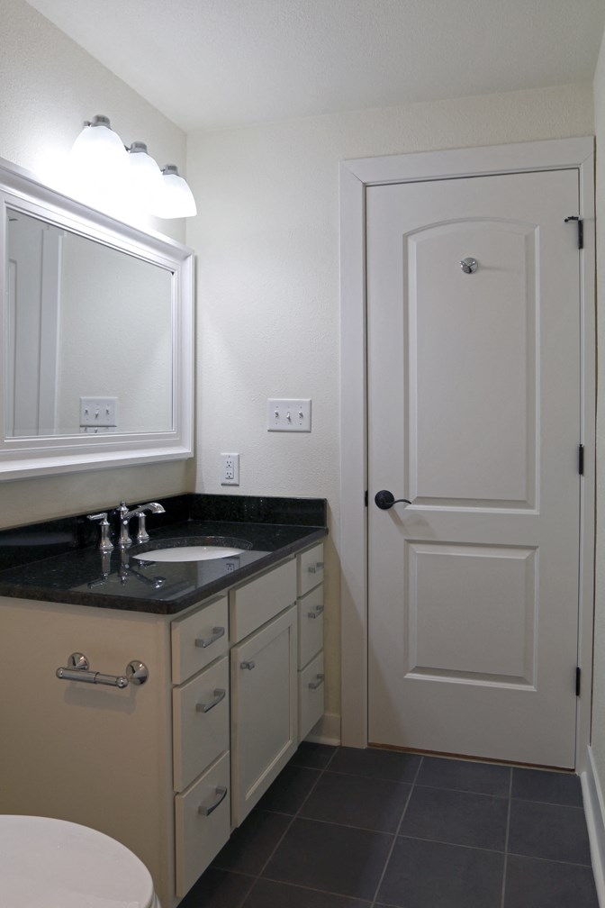 a small bathroom with a sink and a white door