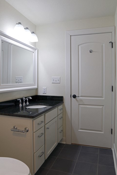 a small bathroom with a sink and a white door