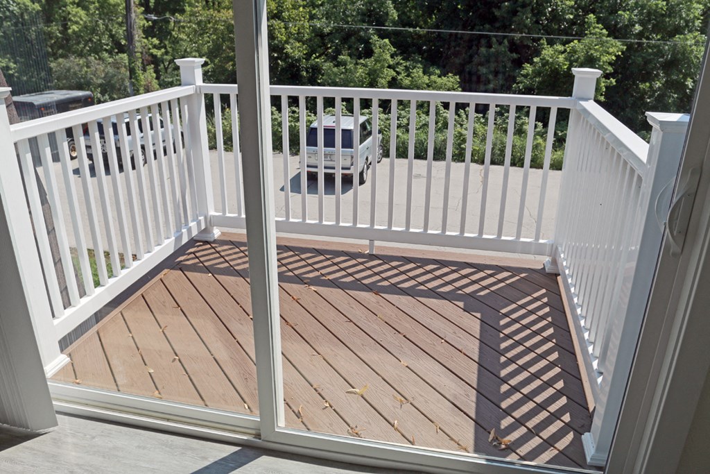 a composite deck with white railing and a guard rail on it
