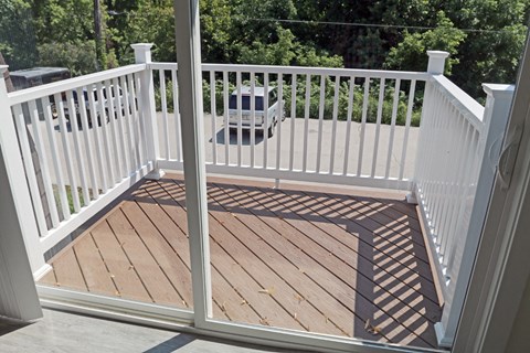 a composite deck with white railing and a guard rail on it