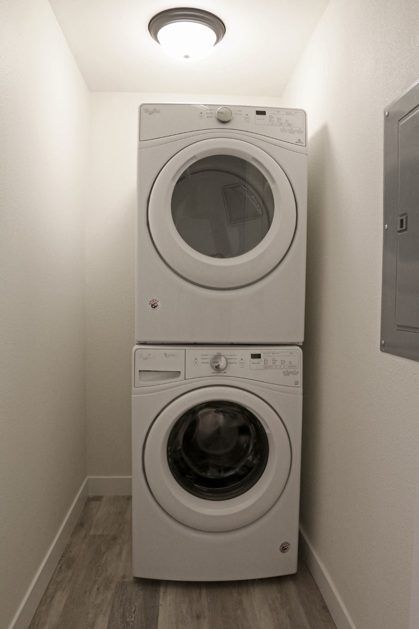 a washing machine and dryer in a small laundry room