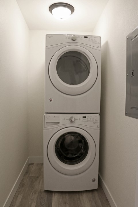 a washing machine and dryer in a small laundry room
