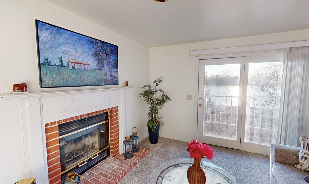 a living room with a fireplace and a painting on the wall