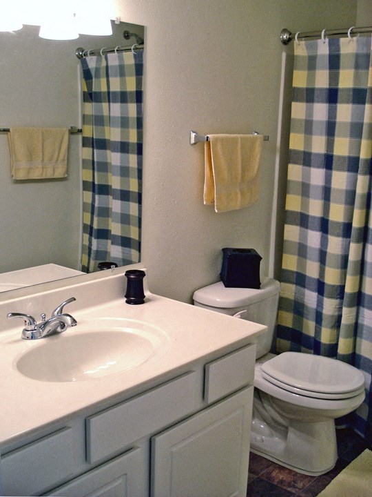 a bathroom with a white sink and a toilet