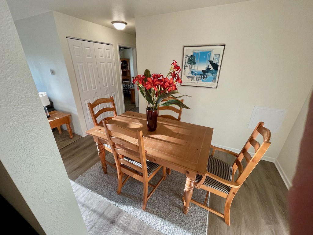 A dining room with a wooden table and chairs.