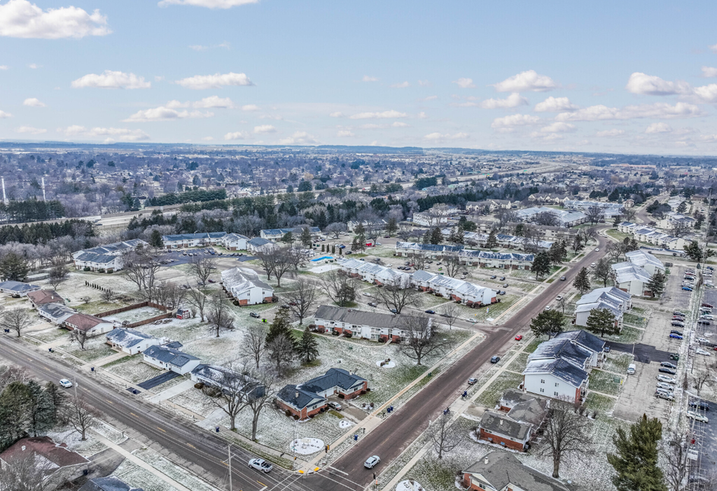 A bird's eye view of a residential area with houses and roads.