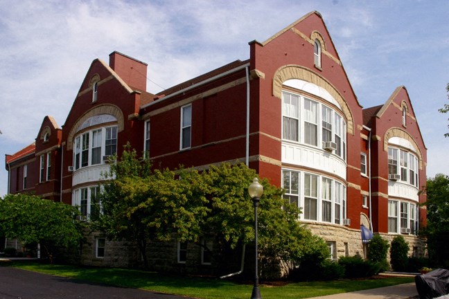 a large brick building with trees in front of it