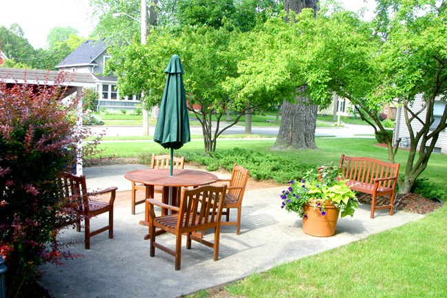 a patio with a table and chairs and an umbrella