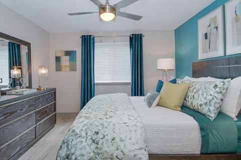 a bedroom with a bed and a ceiling fan