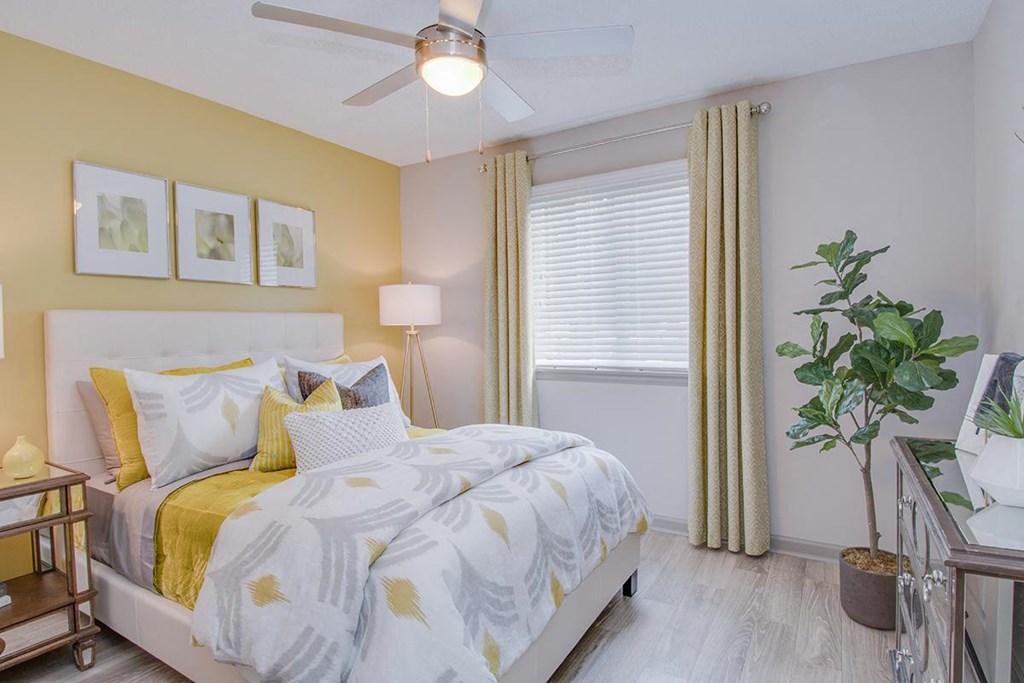 a bedroom with a bed and a ceiling fan