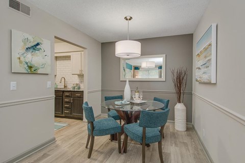 a dining room with a table and chairs