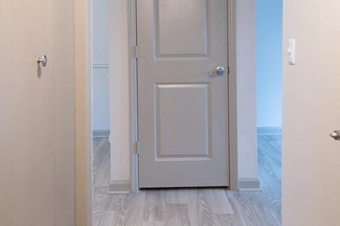 a white door in a room with a blue floor