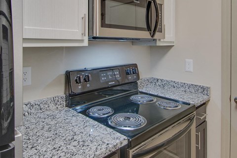 a kitchen with a stove and a microwave