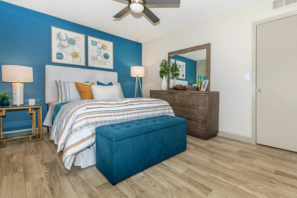 a bedroom with a bed and a ceiling fan