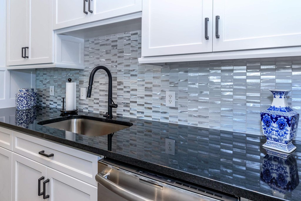 a kitchen with white cabinets and a sink