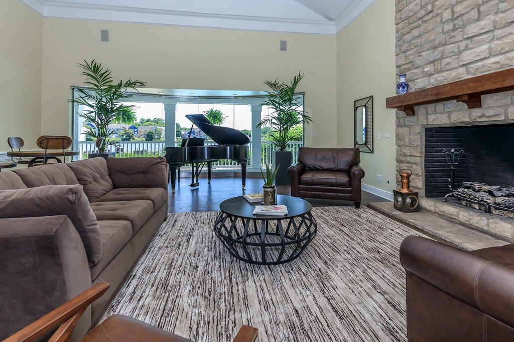 a living room with leather furniture and a fireplace