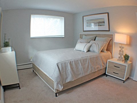 a bedroom with a bed and a window