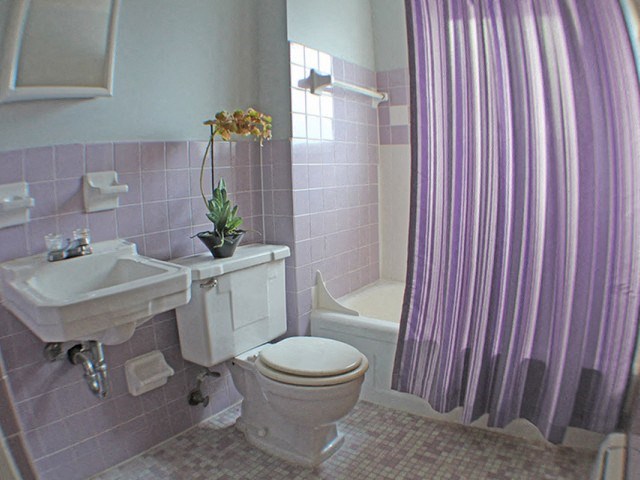a bathroom with a toilet, sink, and bathtub  at Valley York Apartments, Parma Heights, OH, 44130