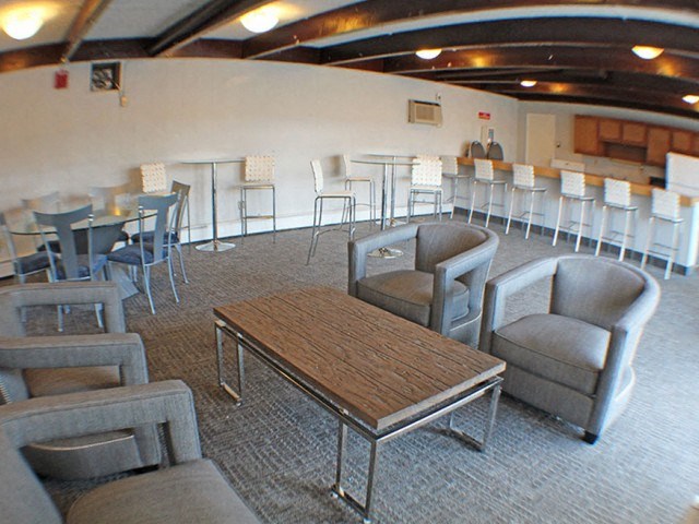 a large community room with tables and chairs  at Valley York Apartments, Parma Heights