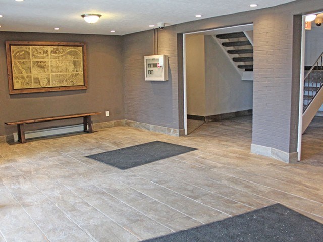 building entry hall with a bench and a painting on the wall  at Valley York Apartments, Parma Heights, OH